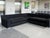 This modern sectional sofa was made by DellaRobbia. It consists of three modular pieces: two long rectangular seats and...