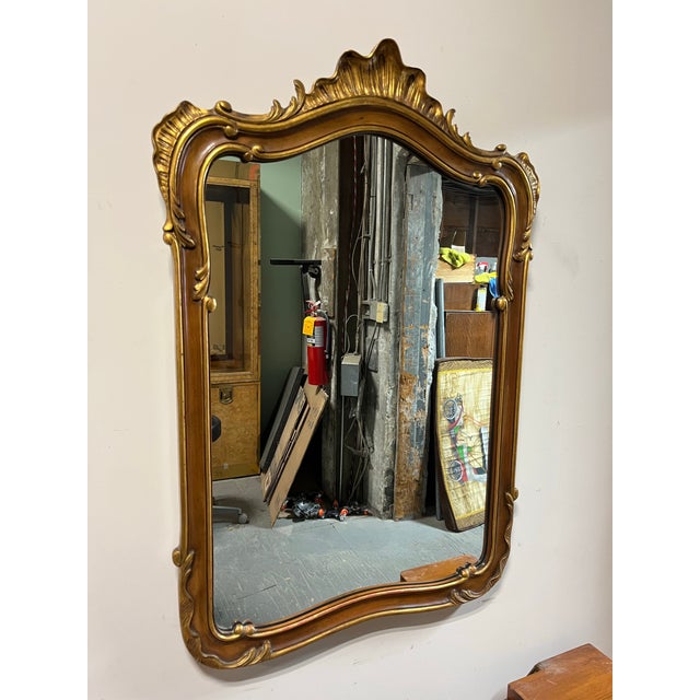 Classic John Widdicomb French Provincial Rocco mirror. Beautifully detailed with sweeping curves topped with foliage or...