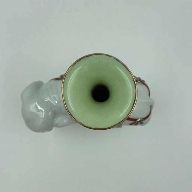 A charming Chinese porcelain elephant-form vessel, hand decorated in the famille rose palette and attributed to the...