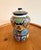 Colorful Mexican pottery jar with a coordinating lid, decorated with intricate floral and geometric patterns. Rich cobalt...