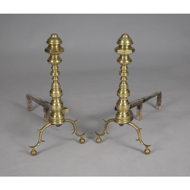 American pair of 18th Century brass andirons with many turnings on the column and beautiful spurred legs on ball feet.