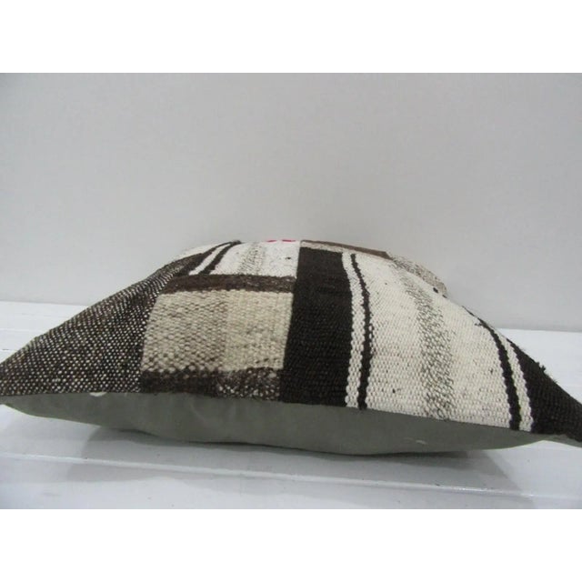 This is a pillow cover made from a vintage kilim rug. The piece was properly washed and ready to use. Pillow inserts not...