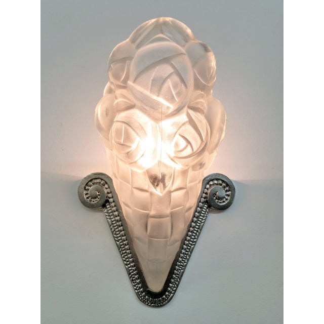 A pair of French Art Deco wall sconces by the French artist " Degue " in great condition. Shades are in clear frosted...