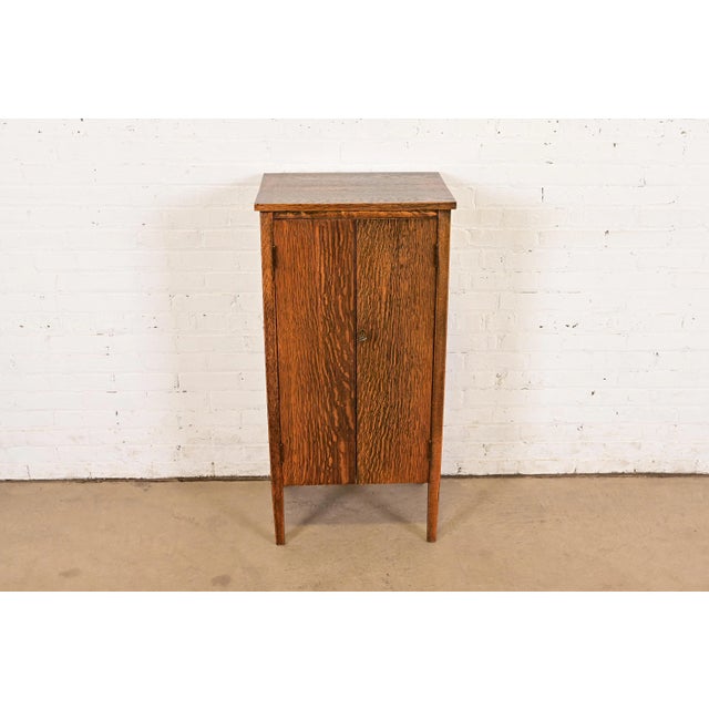 A beautiful antique Mission or Arts & Crafts period tiger oak music cabinet or bar cabinet In the manner of Stickley...