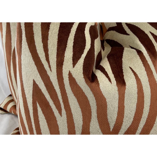 Custom pair of 22" pillows covered in a zebra skin patterned velvet of copper and a creamy beige. These pillows have...