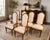 An elegant set of six vintage dining chairs attributed to Mastercraft, featuring the sophisticated combination of...