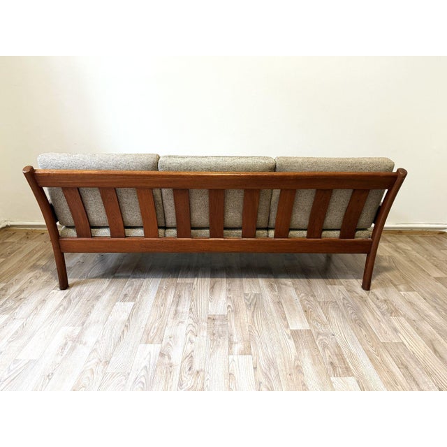 Solid teak frame in very good condition with a mature patina, Reversible cushions are upholstered in original oatmeal-...
