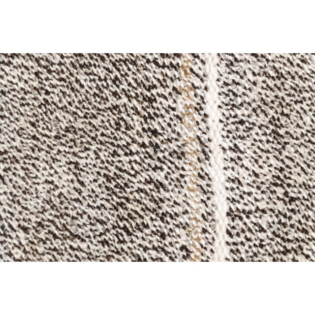 This is a vintage Turkish Oushak rug from the Mid 20th Century. The piece was hand-knotted.