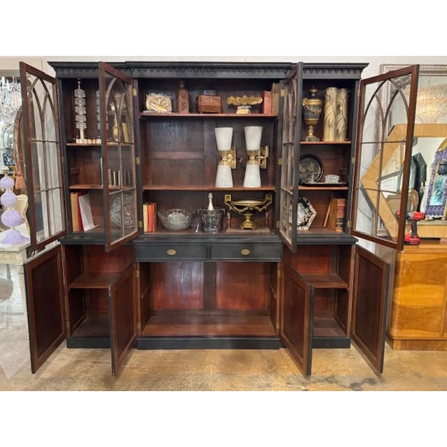 This 19th Century English Painted Mahogany Breakfront Cabinet features a matt black color and a and a traditional...
