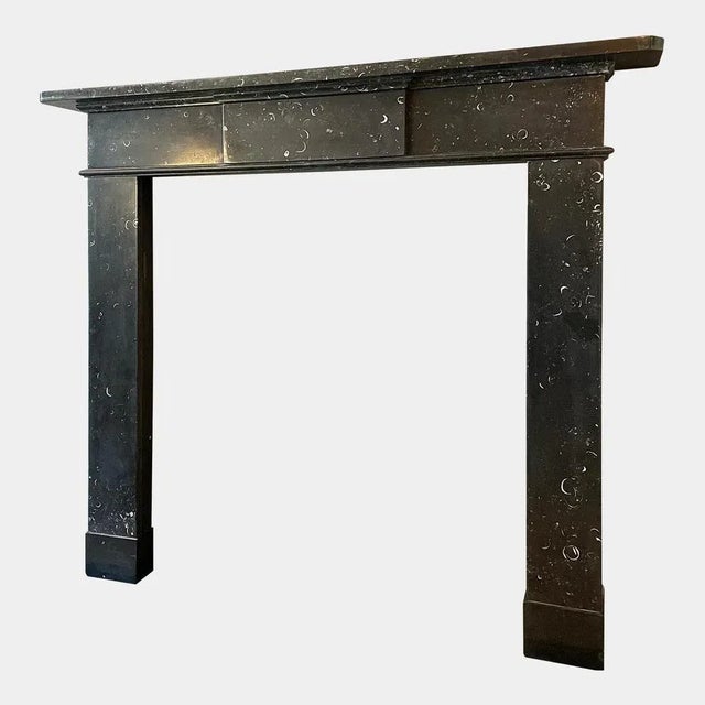 A period george iii late 18th century fireplace in kilkenny marble. Architectural in design with simple jambs stood on...