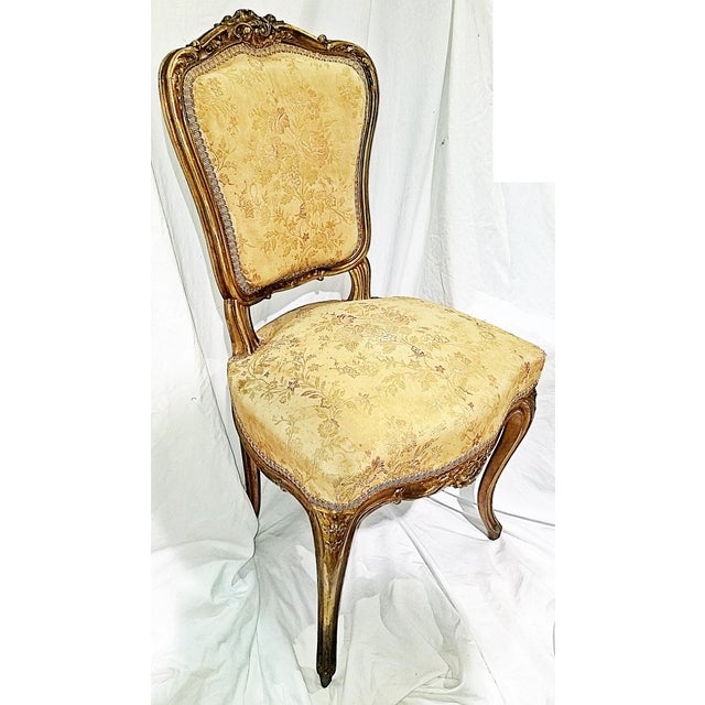 A French staple in any of the classes sitting rooms, this 1880-1890s French Louis XV style gilded parlor chair with rococo...