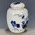 This is a charming vintage porcelain tea jar, decorated in the classic blue and white palette. The jar features a rounded,...