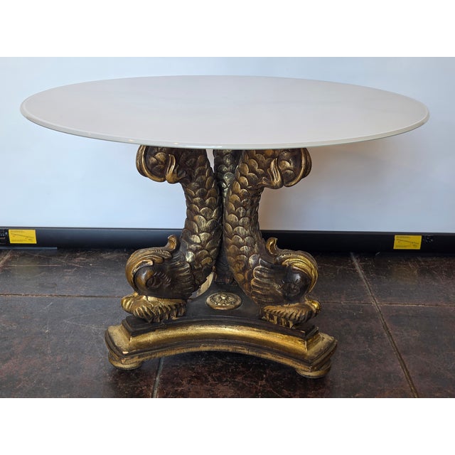 This is a nicely wood carved base from Italy. Has A Faux Carrera Marble Glass Top. 28 round and 19 high. From the 1950s.