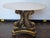 This is a nicely wood carved base from Italy. Has A Faux Carrera Marble Glass Top. 28 round and 19 high. From the 1950s.