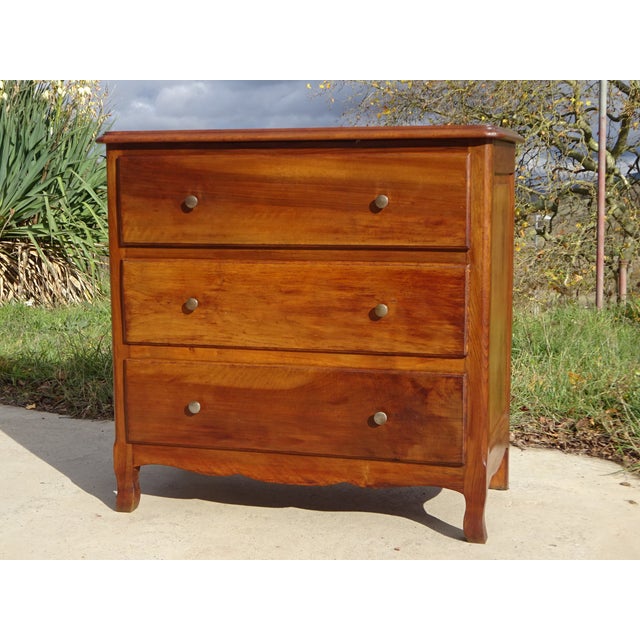 A lovely, simple chest of drawers in solid walnut with three drawers. The top is straight with ogee edges and rounded...