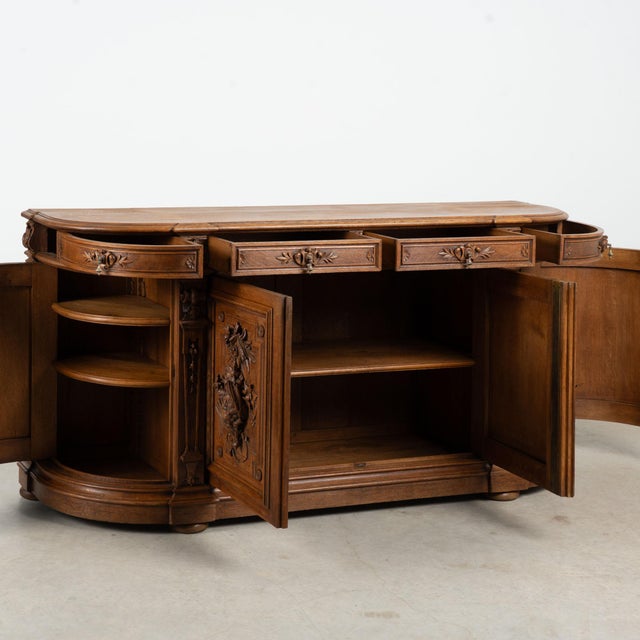 19th century French sideboard, crafted in oak with elaborate carving. The highly decorative carving has dramatic flair...