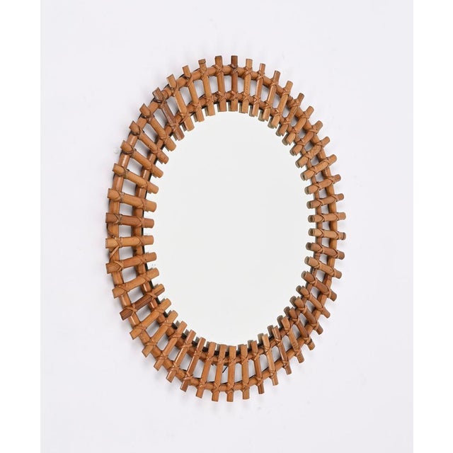 Spectacular mid-century French Riviera style round mirror in rattan, wicker and bamboo. This gorgeous piece was designed...