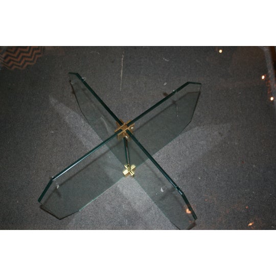 Stunning Mid-Century Modern glass coffee table with beveled glass table top and glass base with brass accents.