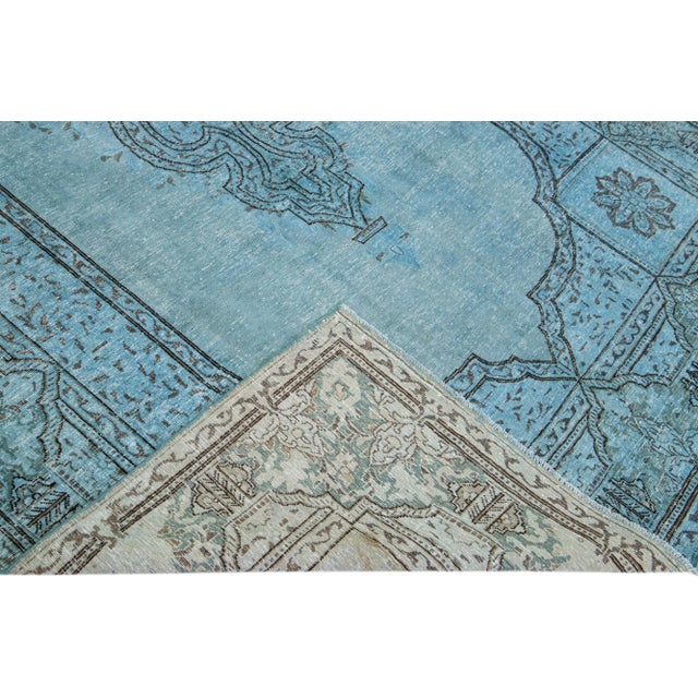 Beautiful Vintage Overdyed hand-knotted wool rug with a blue field. This Persian rug has black and gray accents in an all-...