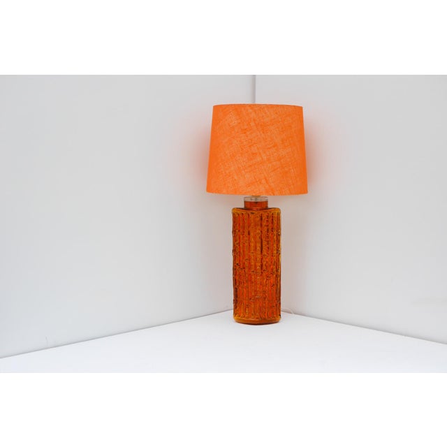 A grand glass table lamp, model rd 1461, designed by gustav leek for the prestigious swedish glassmaker orrefors, produced...