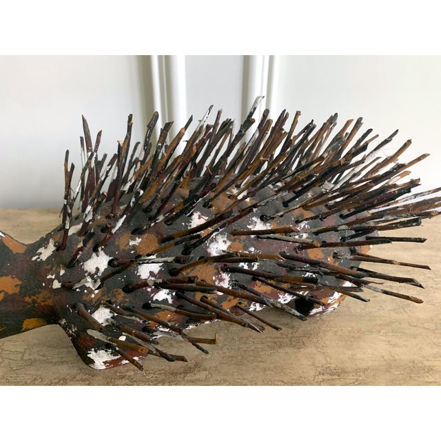 A pair of echidna sculpture carved from wood with found branches made by Australian Aboriginal artist Bob Burruwal (Born...
