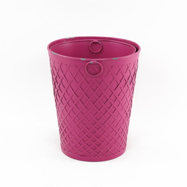 Add a pop of color to your home with this vintage woven metal bucket in a striking deep magenta hue. Featuring an...
