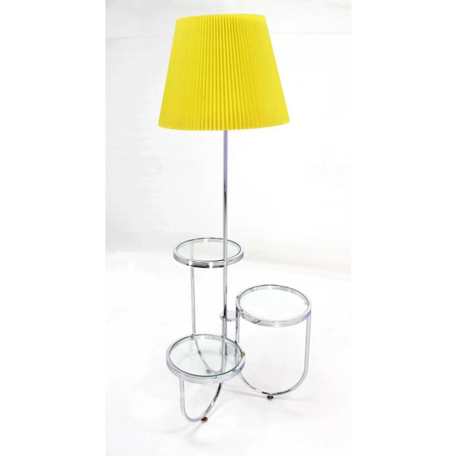 Very cool mid century modern chrome floor lamp with three circular built in tables or stands.