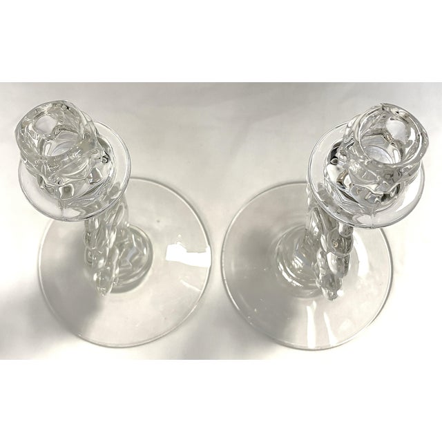 Pretty pair of vintage Heisey Glass candlesticks from the 1940's. Each is made of glass with a grape cluster detail on the...