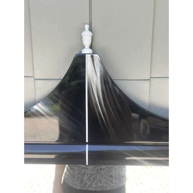 Adorned with black and white accents accompanied by cream faux horn design and coordinating white finials, this modern...