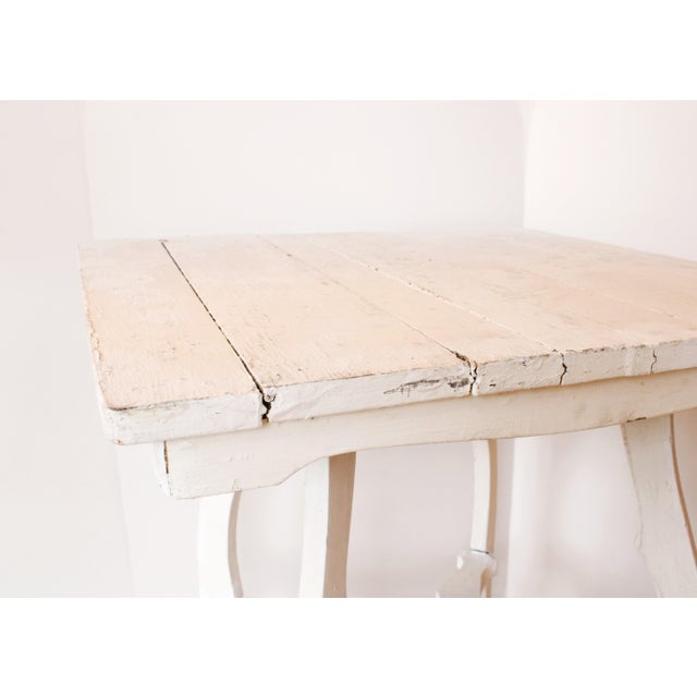 19th Century French side table in weathered white finish with shaped stretchers.