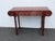 This stunning Console Table is made of ornately carved solid wood. It features a rectangular tabletop with inverted ends...