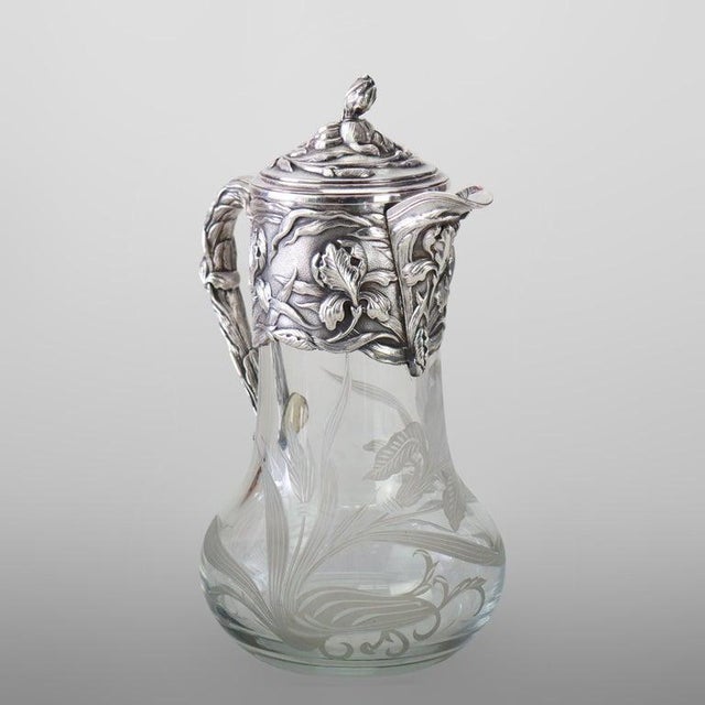 This Art Nouveau claret jug, dating to approximately 1900, features a silver-plated mount and handle crafted by LaPierre...