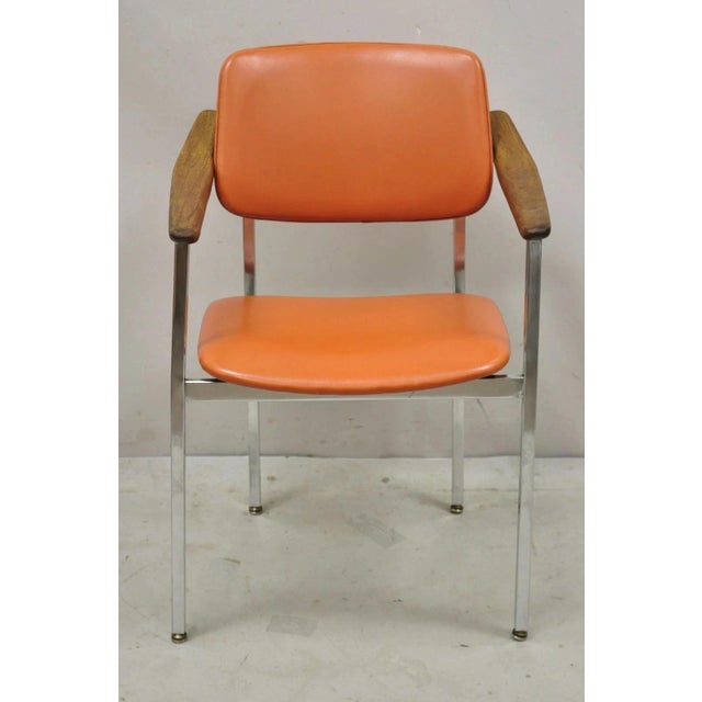 Vintage Mid Century Modern Orange Chrome Frame Sloped Wood Arm Side Desk Chair. Item features orange vinyl upholstery,...