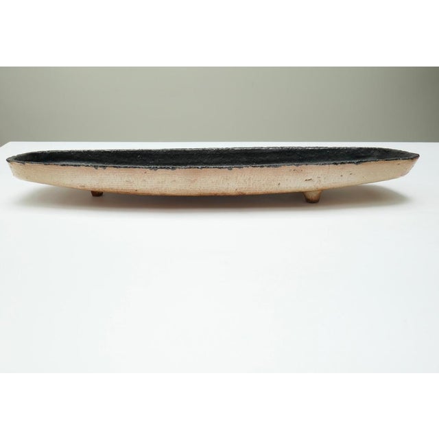 Ovoid brutalist ceramic centrepiece plate with a beautiful combination of strong colours. Stands on 3 legs The 1960s were...