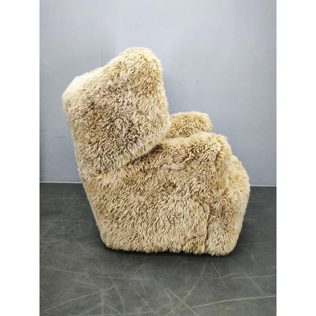 An outstanding 1930s Art Deco wingback armchair, newly upholstered in luxurious Skandilock genuine sheepskin in the...