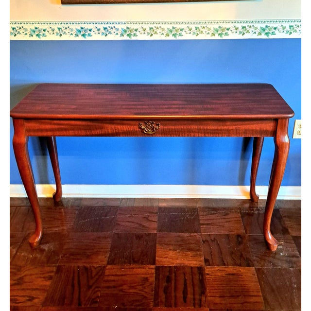 Elegant vintage console table with classic Queen Anne styling and graceful cabriole legs. Finished in a rich dark...