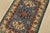 A tribal Caucasian Kazak rug hand-knotted with fine wool on a cotton foundation. This rug features geometric medallions...