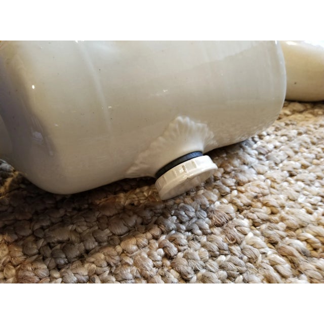 Collection of three antique English stoneware bed or foot warmers with screw top lids. The smaller darker stoneware one...