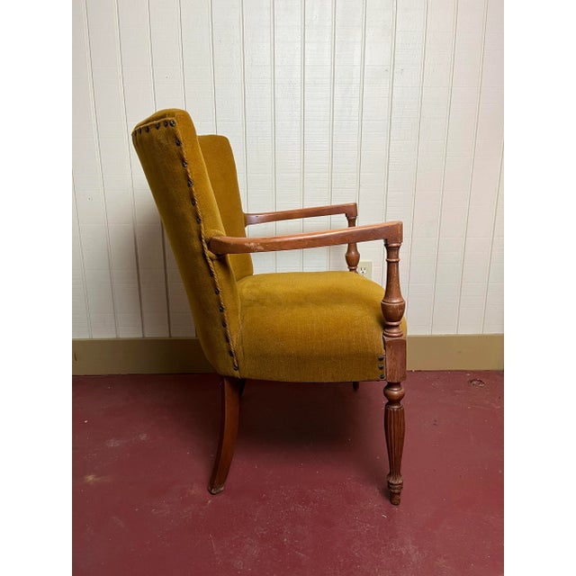 Vintage button-detail upholstered armchair with decorative tacks and turned front legs