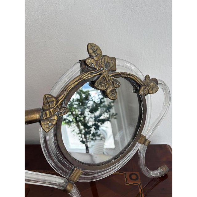 Rare Murano glass table mirror, 1949 The circular mirror is crowned by an ornate metal finial (patinated bronze) featuring...