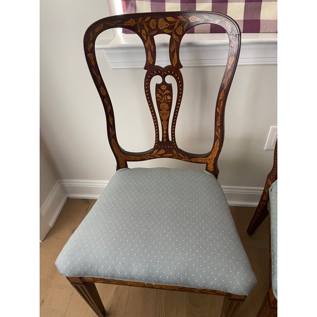 Beautiful pair of antique marquetry chairs from the late 19th century. The chairs have elaborate floral decorations...