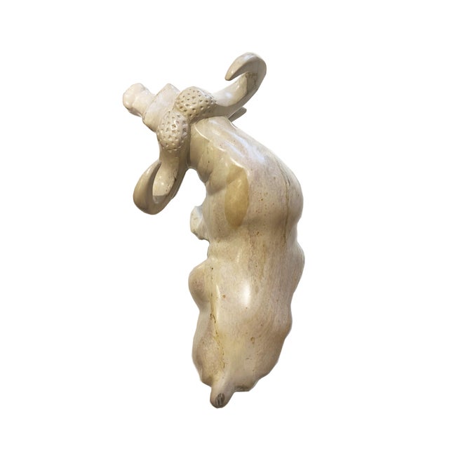 A found soapstone cattle statue, carved with realistic details captured in the cattle's face, bringing the statue to life...