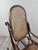 An elegant bentwood rocking chair in the style of Thonet's designs, featuring superb, flowing, and harmonious lines. The...