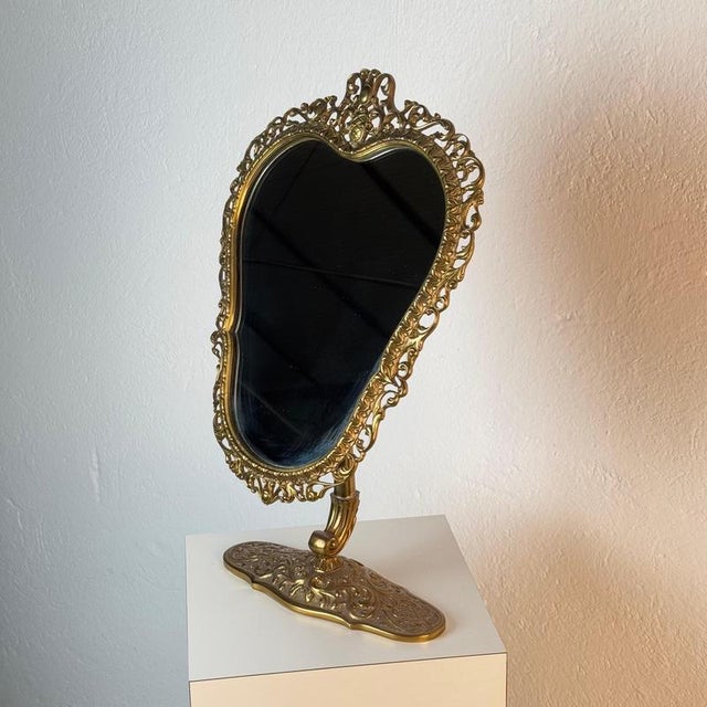 An exquisite Italian table mirror of remarkable refinement, executed in finely cast and hand-finished brass, and...