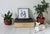 Vintage Chinese porcelain tile on footed metal base. Could serve as a plant stand or a place to set your coffee down....