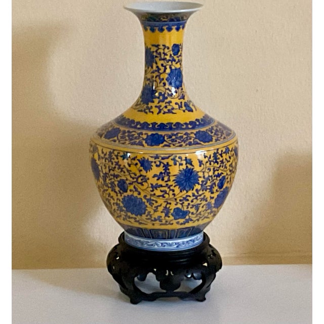 This vase has a colorfully vibrant yellow and blue floral hand painted design that captivates your attention and...