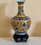 This vase has a colorfully vibrant yellow and blue floral hand painted design that captivates your attention and...