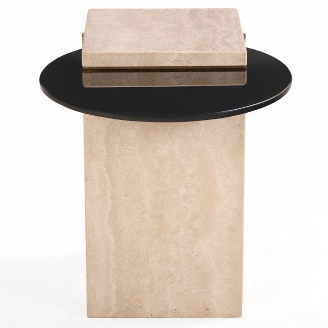 With a Postmodernist design similar to the Artedi style, this Italian side table combines natural travertine with a glass...