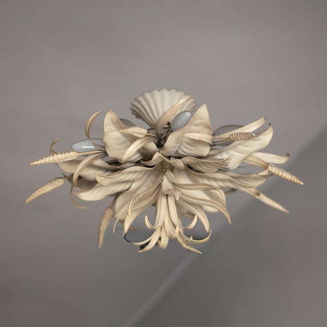 Large lacquered iron ceiling light from the 1970s. Made in Italy in the Fornasetti style. Floral structure with 9 lights....