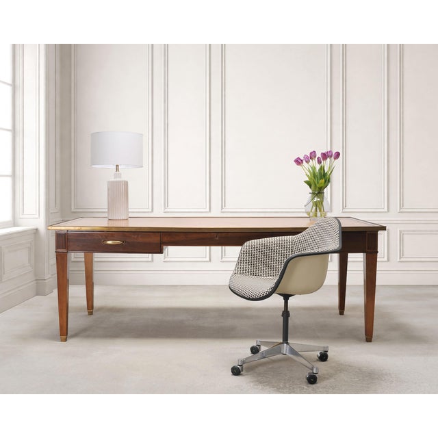 A grand French mid-century modern bureau plat writing desk, or library table constructed from fruitwood with an inset...